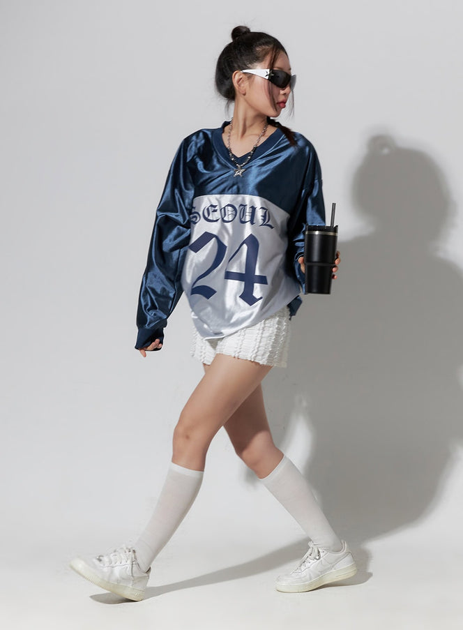 Dark Blue Lettered Poly Sweat V-Neck Hoodie IO409 in dark blue, full-body walking shot, SEOUL 24 old-English lettering on silver panel, styled with white mini skirt and knee socks.
