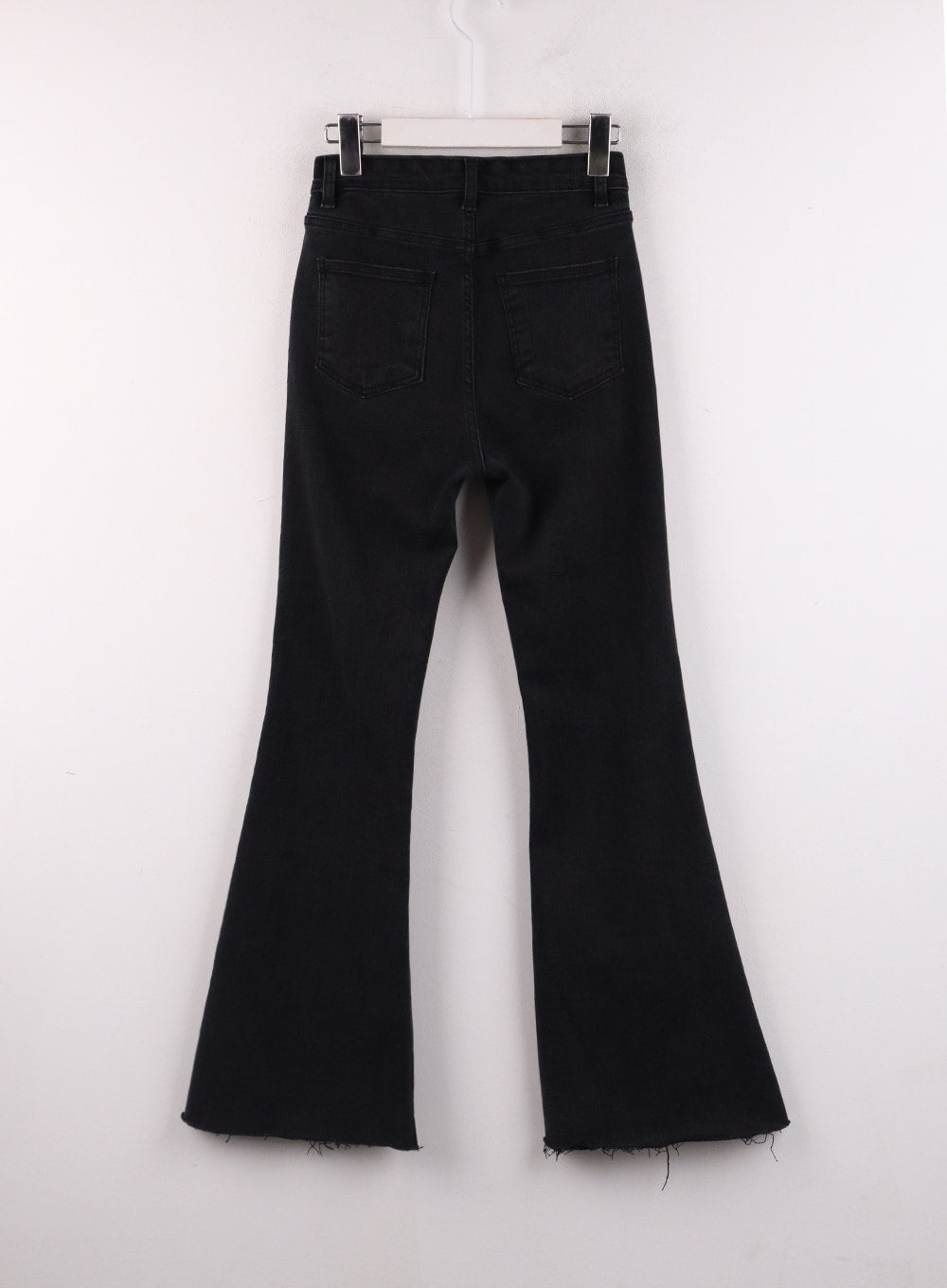 Mid Waist Button Flared Jeans IF402 in black, flat hanger back shot, dual back pockets with contrast stitching, wide bootcut flare, raw frayed hem visible, clean solid black denim construction.