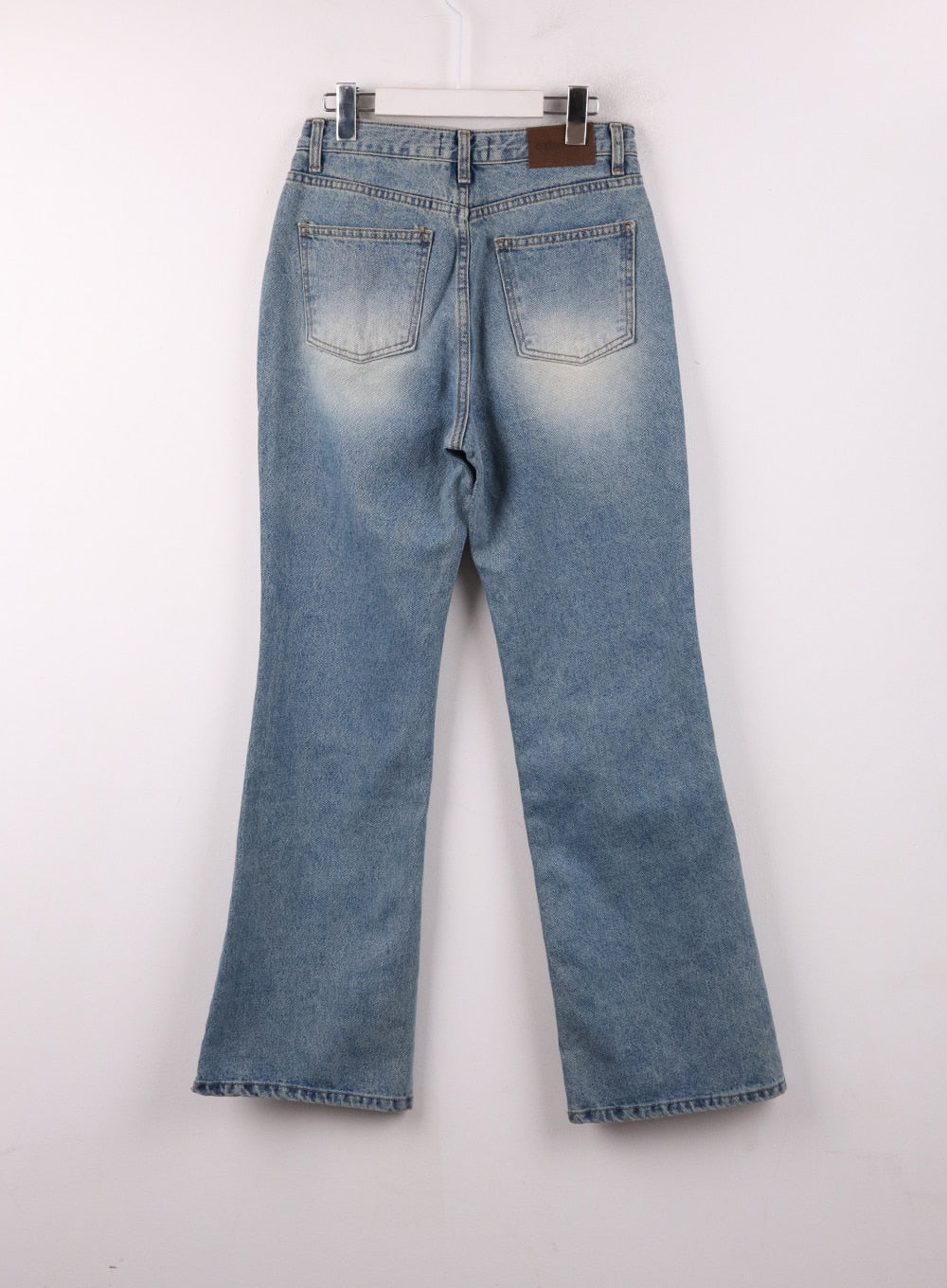 Washed Straight Leg Bootcuts Jeans IJ430 in light blue, flat back product shot on hanger, dual back pockets with stitching detail, leather brand patch, washed denim texture, bootcut hem.