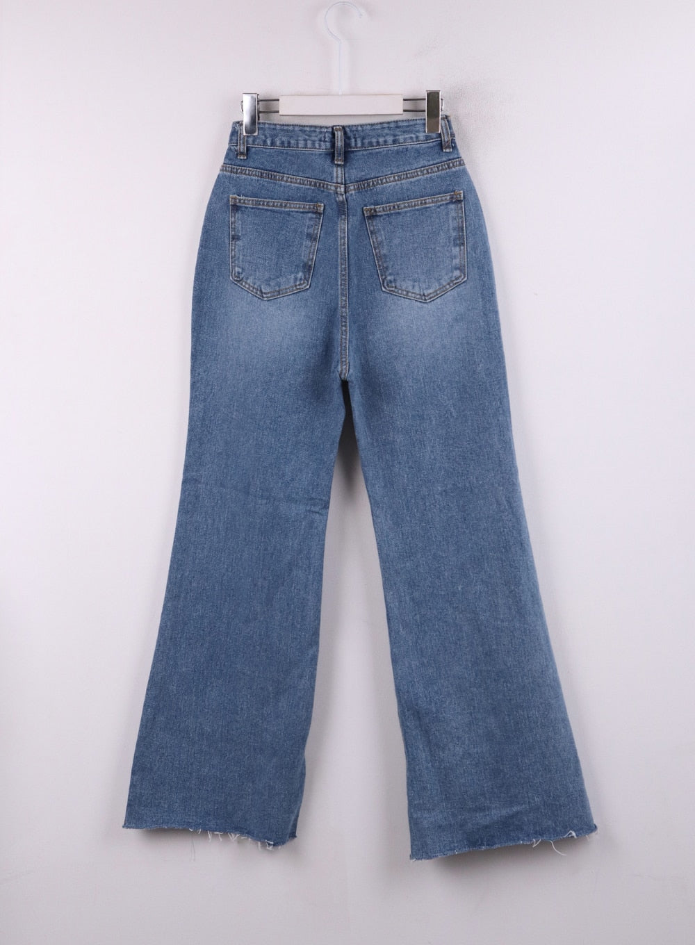 Blue Denim Bootcut Jeans CJ431 in blue, flat back hanger shot, showing two back patch pockets with topstitching, washed denim with wide bootcut leg and raw frayed hem detail.