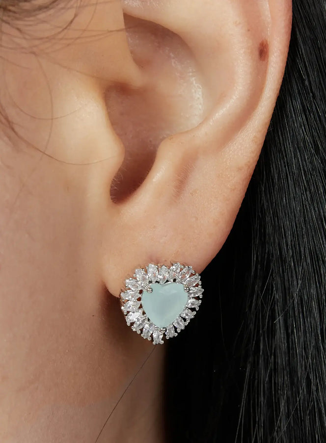 LEWKIN Fellini Earring IU503 in mint, ear close-up on model, heart-shaped bead center framed by sparkling crystal baguette halo, silver-tone stud setting.