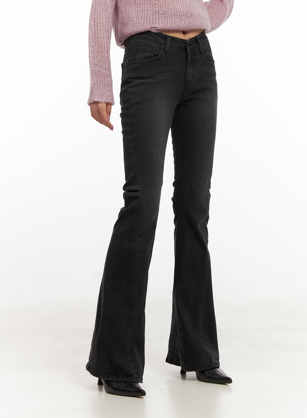 Belle Slim Fit Flared Jeans CD410 in black, angled front close-up on model, low-waist button fly and front pockets visible, washed slim-fit denim flaring at hem.
