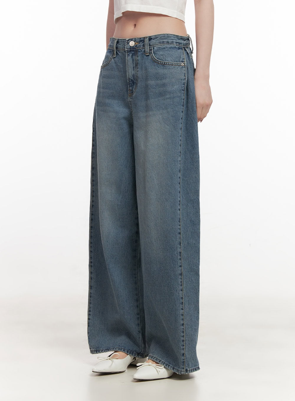 Andrea Wide-Leg Jeans CF514 in blue, front three-quarter shot on model, wide-leg washed denim, pintuck front crease, mid-rise waist, paired with white crop top and ballet flats.