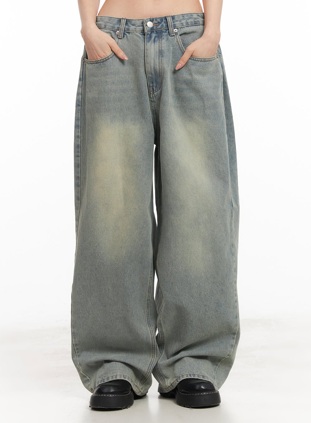 Hillary Washed Wide-Leg Jeans CM504 in light blue, front mid-shot on model hands in pockets, wide baggy silhouette with washed pintuck denim pooling at black loafers.