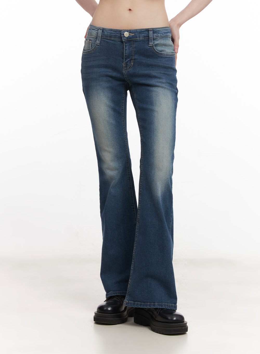 Rebecca Low-Waist Flared Jeans CM519 in dark blue, front cropped view on model, close-up of low-rise waistband, front pockets, and washed indigo denim with vintage fading.