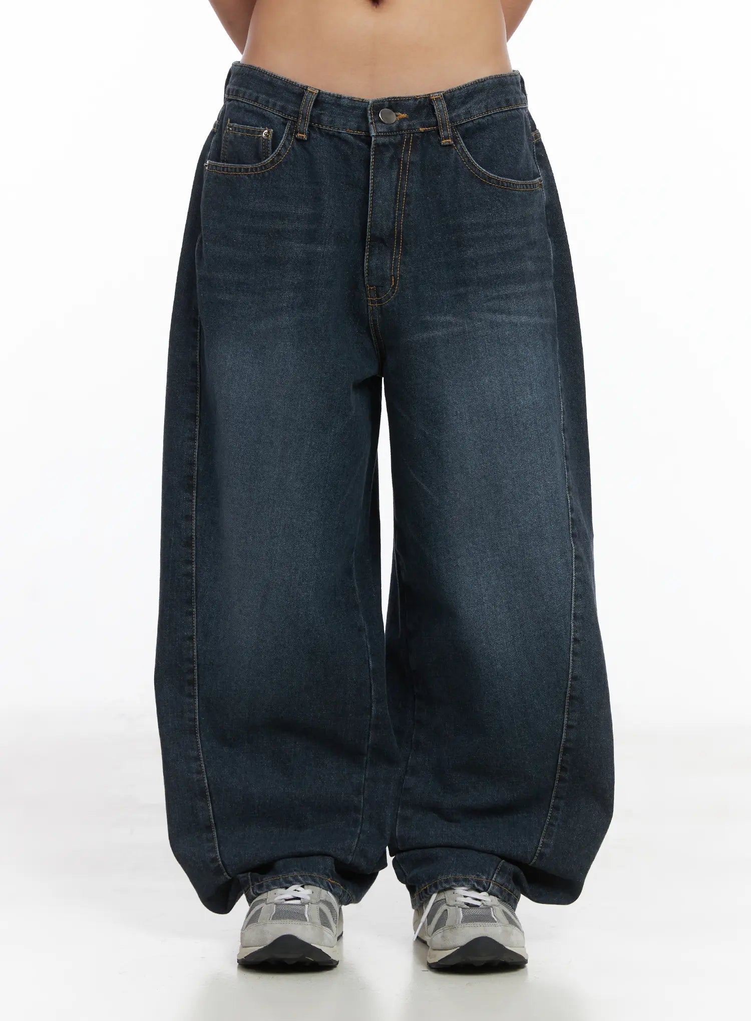Everly Wide Leg Jeans CJ513 in dark blue, front product-focused view on model, washed wide-fit denim with five-pocket design, button fly, and contrast topstitching, hem stacking over grey sneakers.