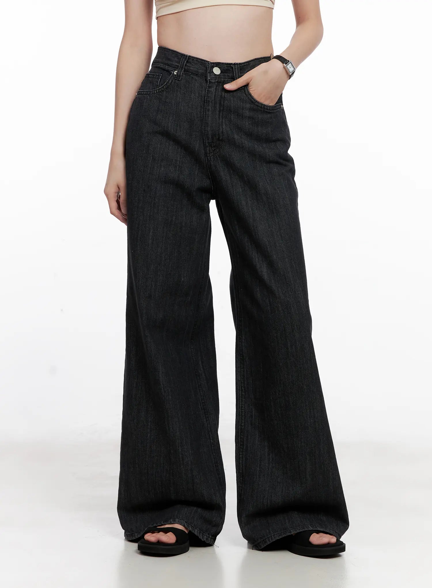 Yeon High-Waist Wide Jeans CL523 in black, front close-up on model, high-waist button fly detail, front coin pocket, wide-leg cotton denim with subtle vertical texture.