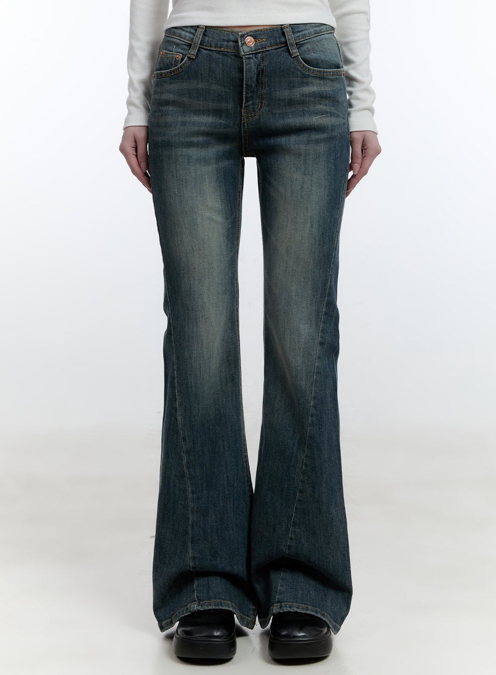 Mallory Skinny Bootcut Jeans CJ520 in blue, front straight-on view on model, low-rise slim washed denim with washed tonal fading, bootcut flare and copper button detail at waist.