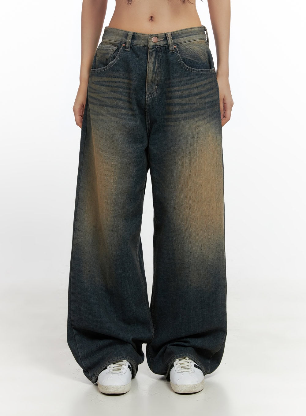 Bryana Cotton Comfort Wide Leg Jeans CN419 in dark blue, front mid-shot on model, low-rise waistband with five-pocket styling, heavy amber vintage wash on cotton denim, extra-wide leg, white sneakers.