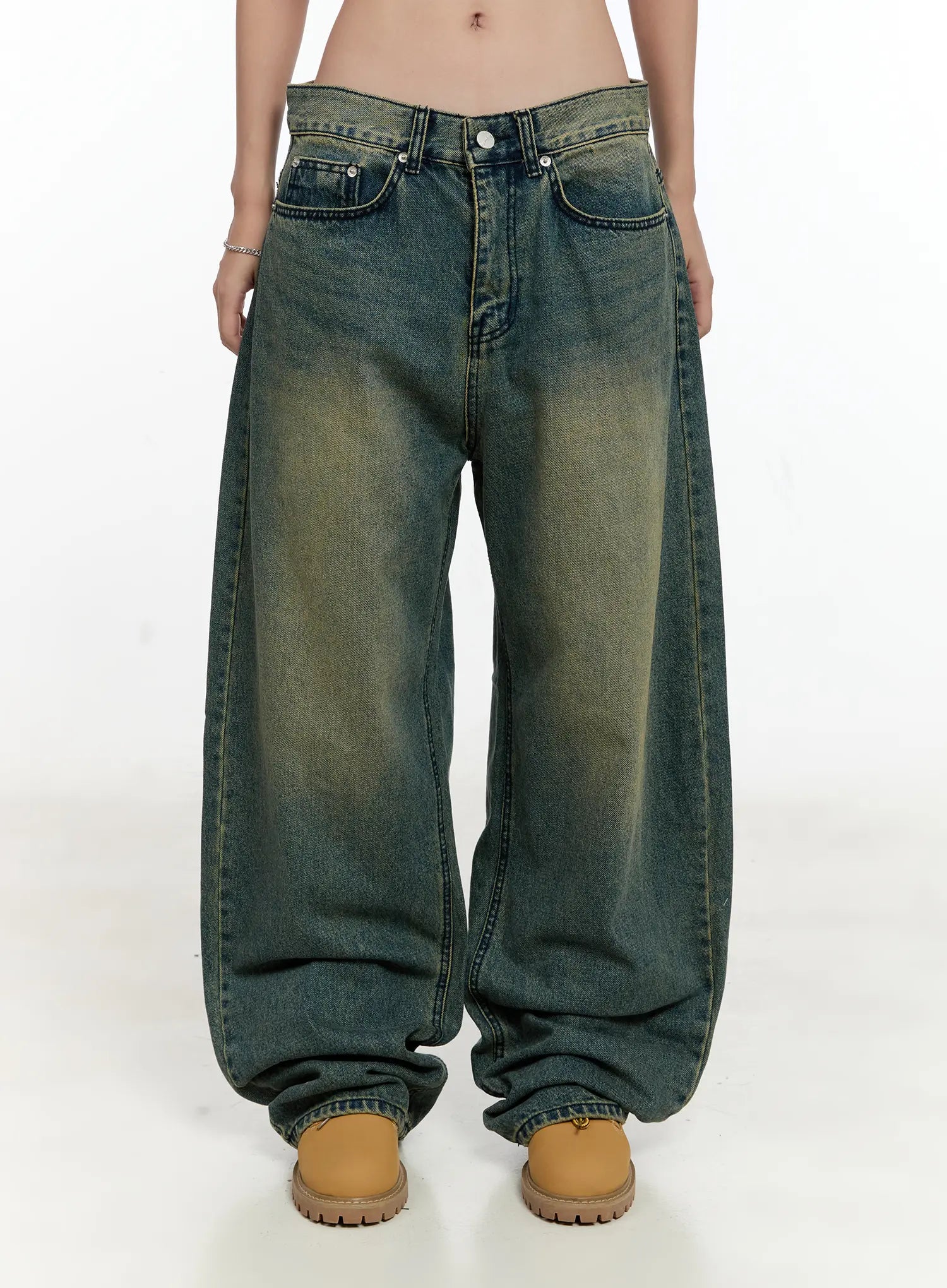 Sooyoung Baggy Vintage Wash Jeans CL531 in dark blue, front lower-body view on model, wide-leg baggy fit with yellow-green vintage wash gradient, button fly, front pockets, hem pooling over boots.