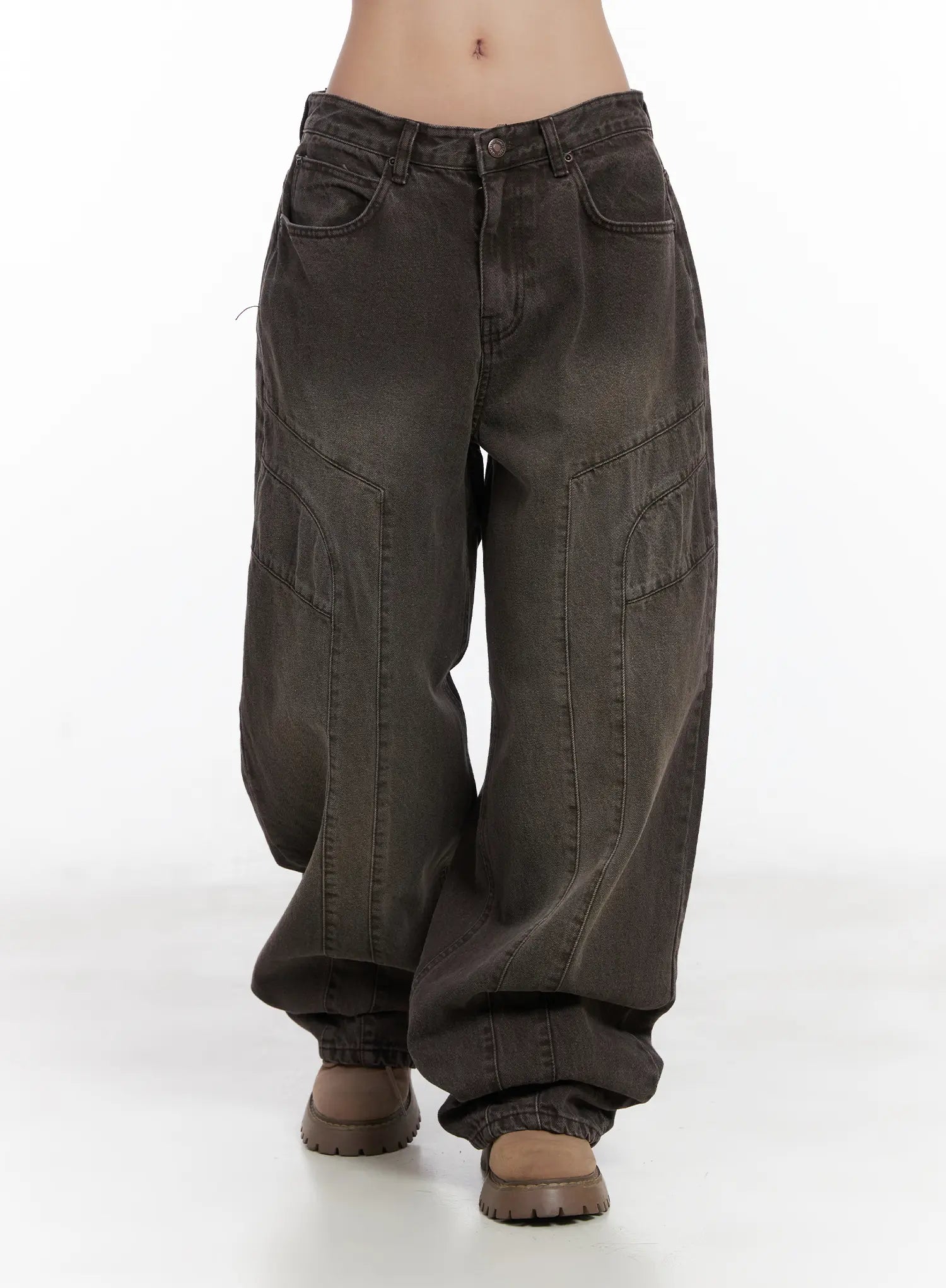 Elia Washed Baggy Jeans CN528 in dark brown, front walking shot from waist down, wide-fit washed cotton with panel seams, cargo-style pockets, and stacked hem over boots.