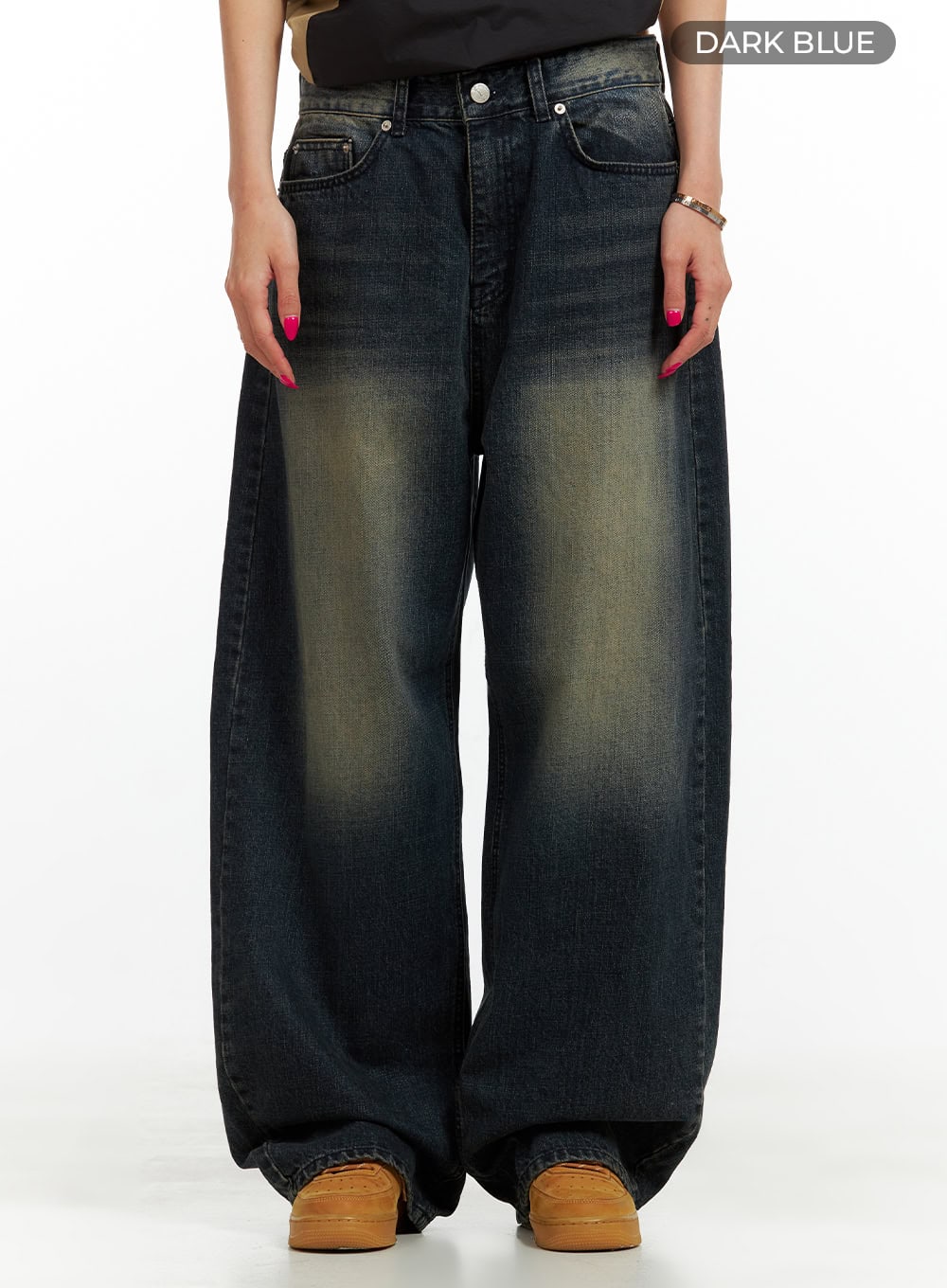 Solid Low Rise Baggy Jeans CU417 in dark blue, front product shot on model, low-waist wide-fit washed denim with bold yellow fade at thighs, five-pocket styling and button fly.