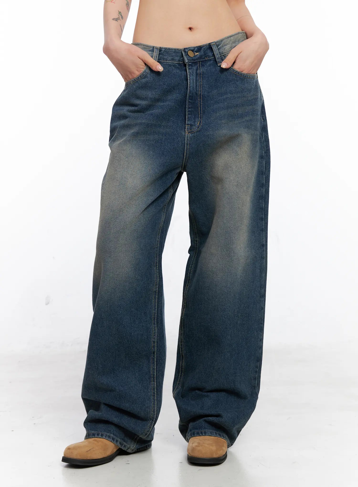Xyla Vintage Pocket Baggy Jeans CO507 in blue, front view on model hands in pockets, loose-fit washed cotton denim with wide leg and vintage faded wash, tan boots.