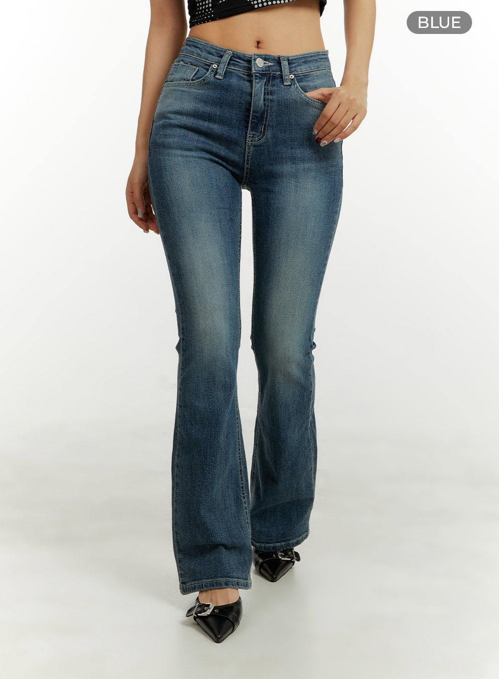 Low Rise Bootcut Jeans CY409 in blue, front walking shot on model, low-rise slim fit, washed bootcut denim, paired with black sparkle crop top and buckle heels.