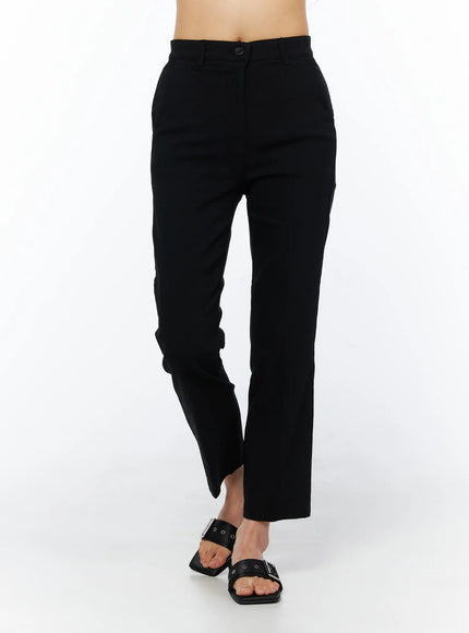 Hip-Pad Capri Pants CU522 in black, front walking-pose shot on model, tailored high-rise capri with straight leg and button waistband, cropped ankle length.