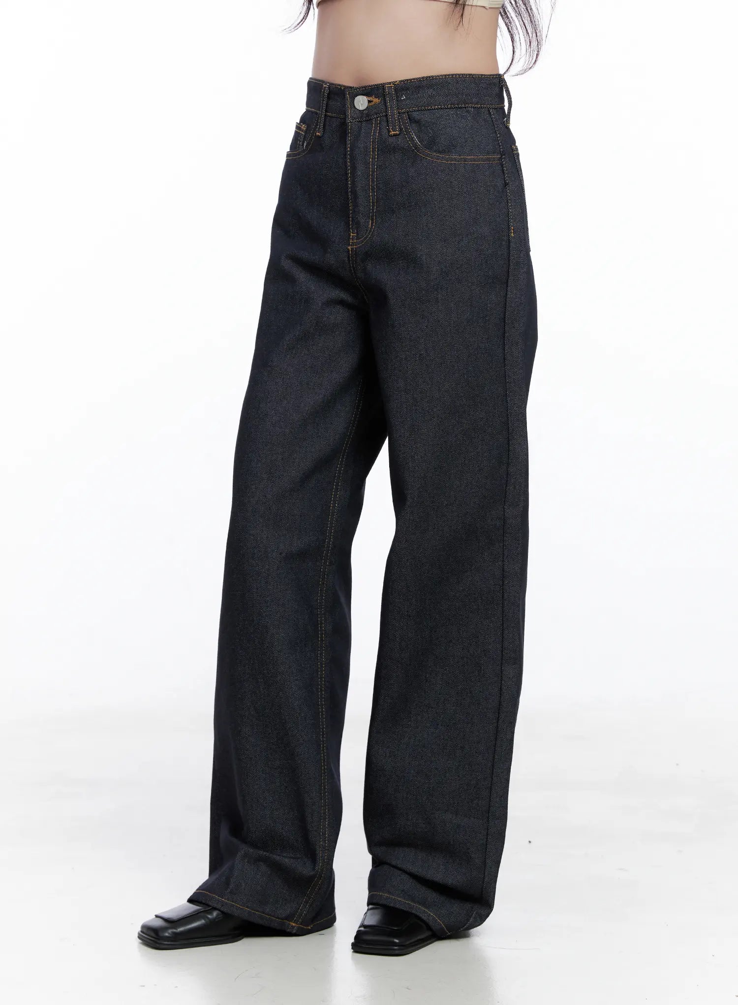 Reyna Non-Fade Relaxed Jeans CS519 in dark blue, side-angle product shot on model, highlighting high-waist fit, wide relaxed leg, contrast gold stitching, and long floor-grazing length with black loafers.
