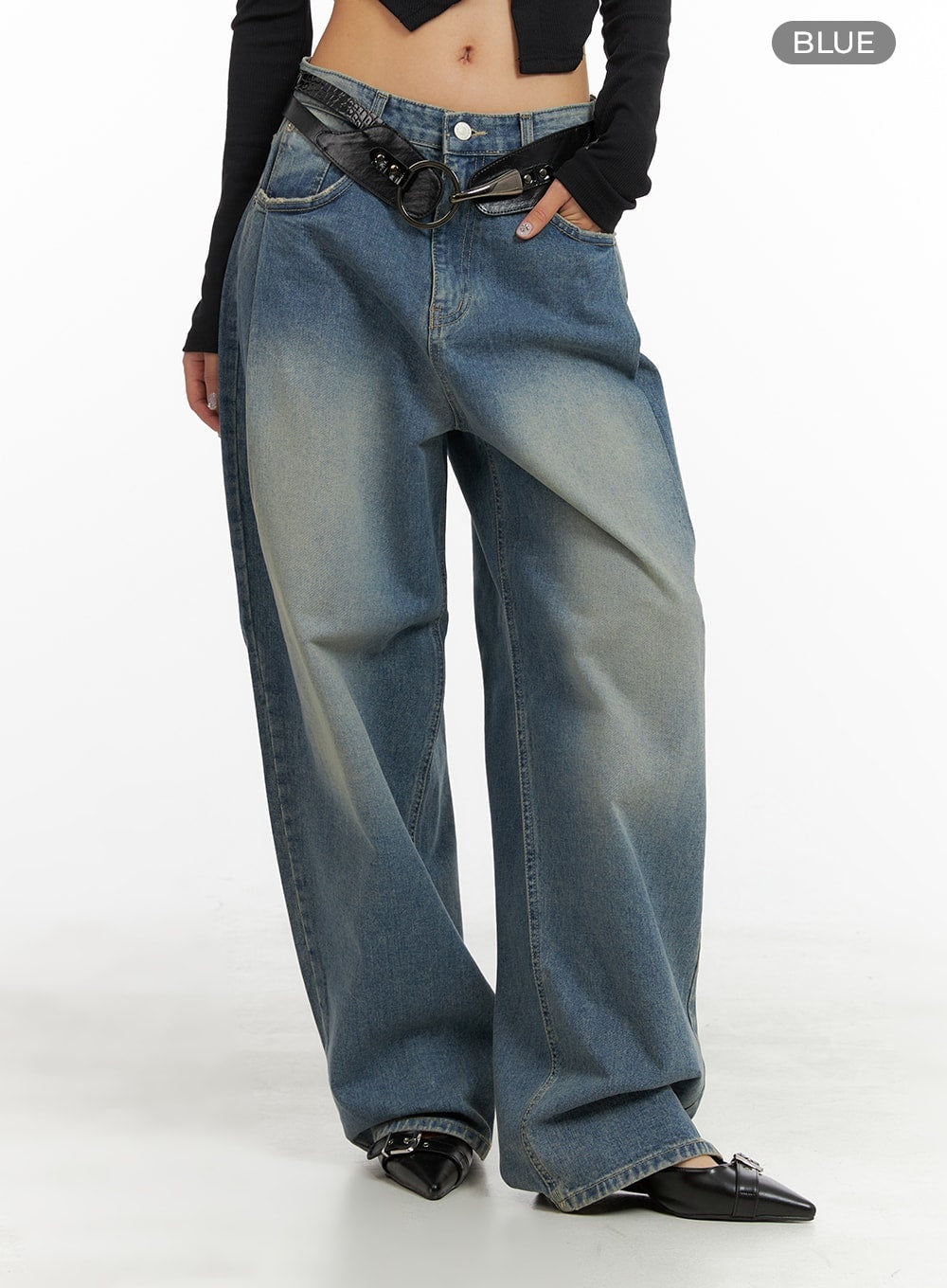Washed Out Wide Fit Baggy Jeans CA416 in blue, front three-quarter shot on model, low-rise wide baggy fit with washed gradient denim and center seam, black belt styling.