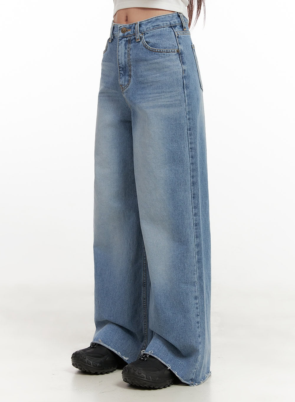 Melody Chic Flare Wide Leg Jeans CN428 in light blue, close-up side view from hip to hem on model, highlighting washed denim texture, high-rise fit, flare silhouette, and destroyed raw hem edge.