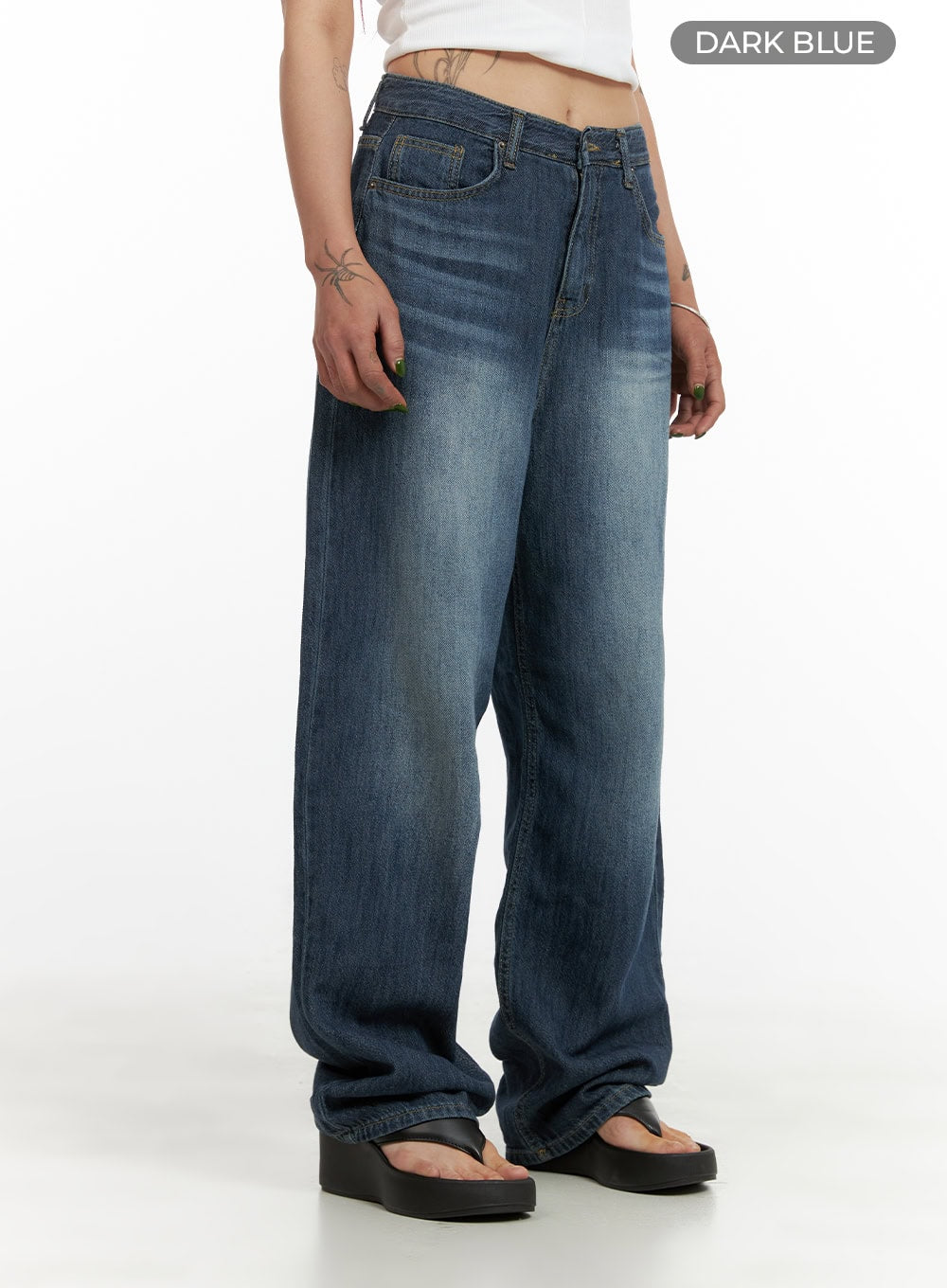 Wide Fit Baggy Jeans CY430 in dark blue, angled side close-up on model, washed denim with wide-fit baggy leg, whisker fading at hip and gathered hem over black thong sandals.