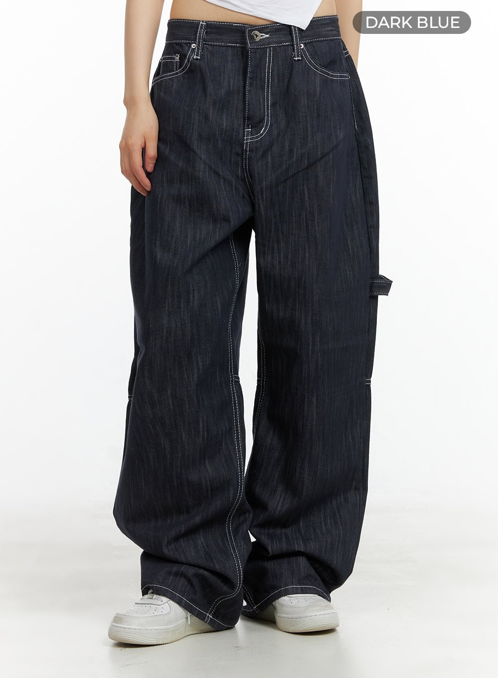 Low-Rise Strap Baggy Jeans CY414 in dark blue, color swatch front crop shot on model, low-rise fit with contrast white stitching and wide baggy leg, styled with white sneakers.