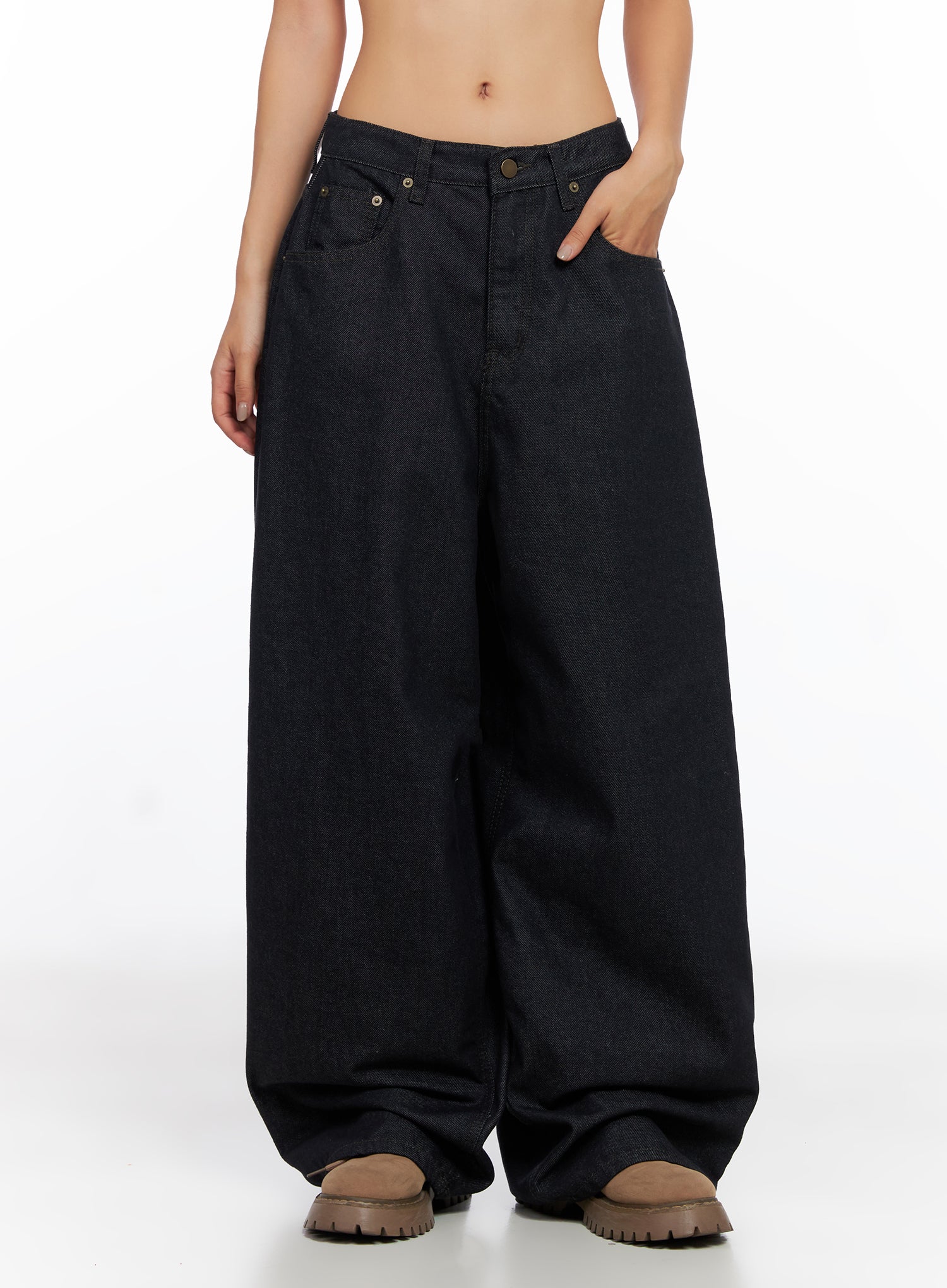 Miller Balloon Baggy Jeans CO515 in dark blue, front three-quarter crop view on model, hand in pocket, low-rise waist, balloon wide leg, brass hardware, dark cotton denim.