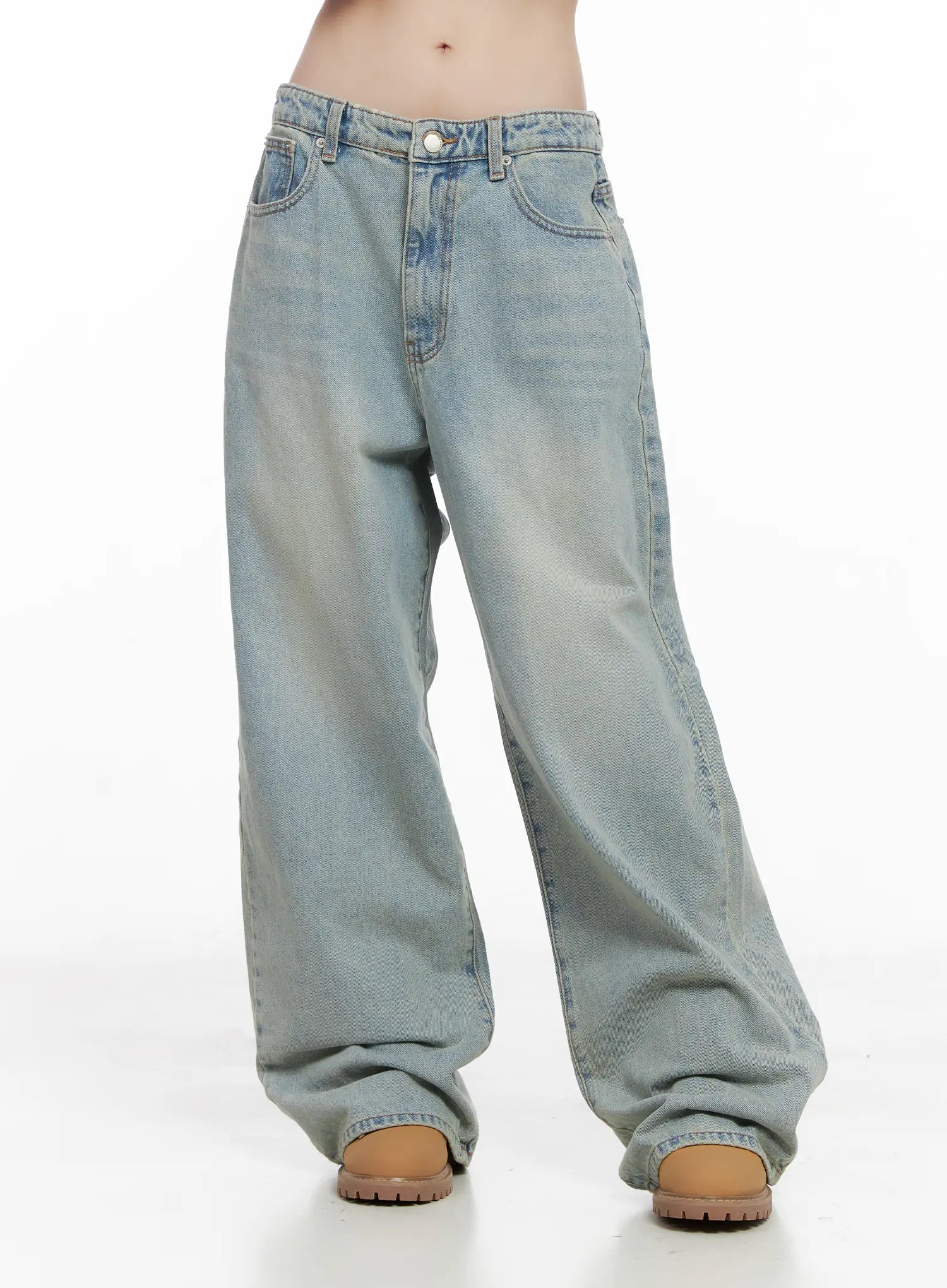 Lilly Light Wash Baggy Jeans CG519 in light blue, front cropped view from waist to floor, baggy wide-leg fit with faded wash, front pockets, and floor-length hem over tan boots.