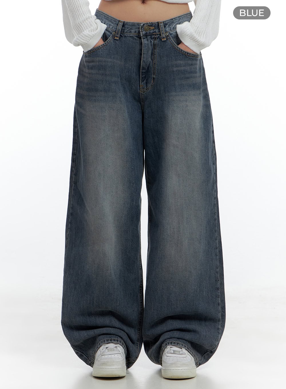 Lana Oversized Wide-Leg Jeans CS425 in blue, front product-style view with hands in pockets, washed denim, low-rise waistband with button fly, extra-wide baggy leg, styled with white knit crop top.
