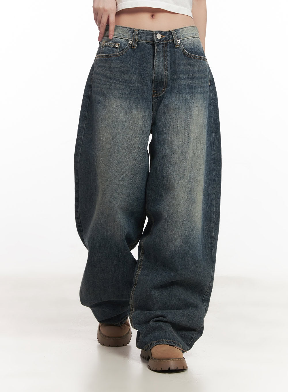Leilani Washed Baggy Jeans CM531 in dark blue, front waist-to-toe shot on model walking, wide-fit washed denim with heavy hem pooling and whiskered fading at thighs.