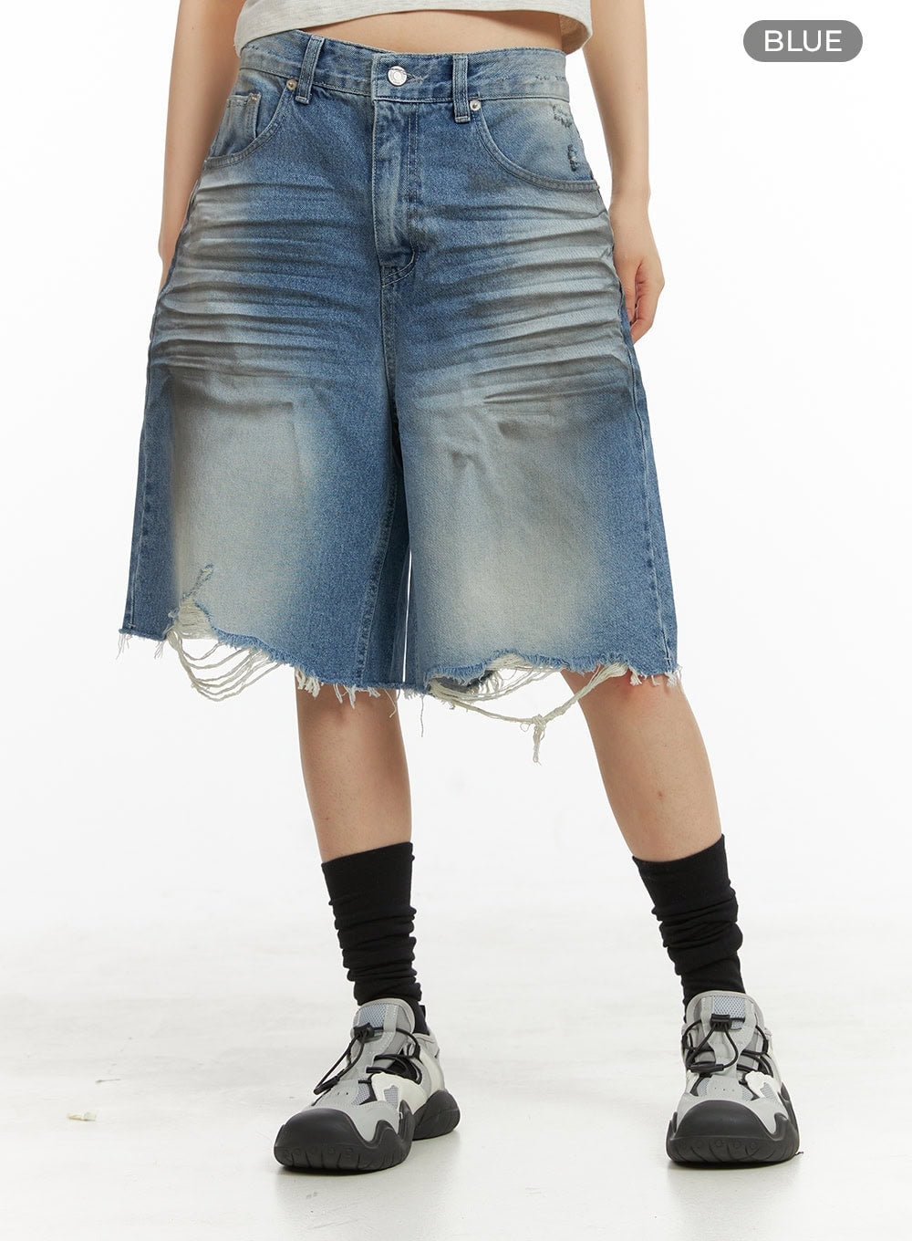 Destroyed Hem Bermuda Jorts CY414 in blue, front product shot on model from waist down, wide-fit midi washed denim with grunge destroyed fray hem, color label visible, paired with black socks and sneakers.