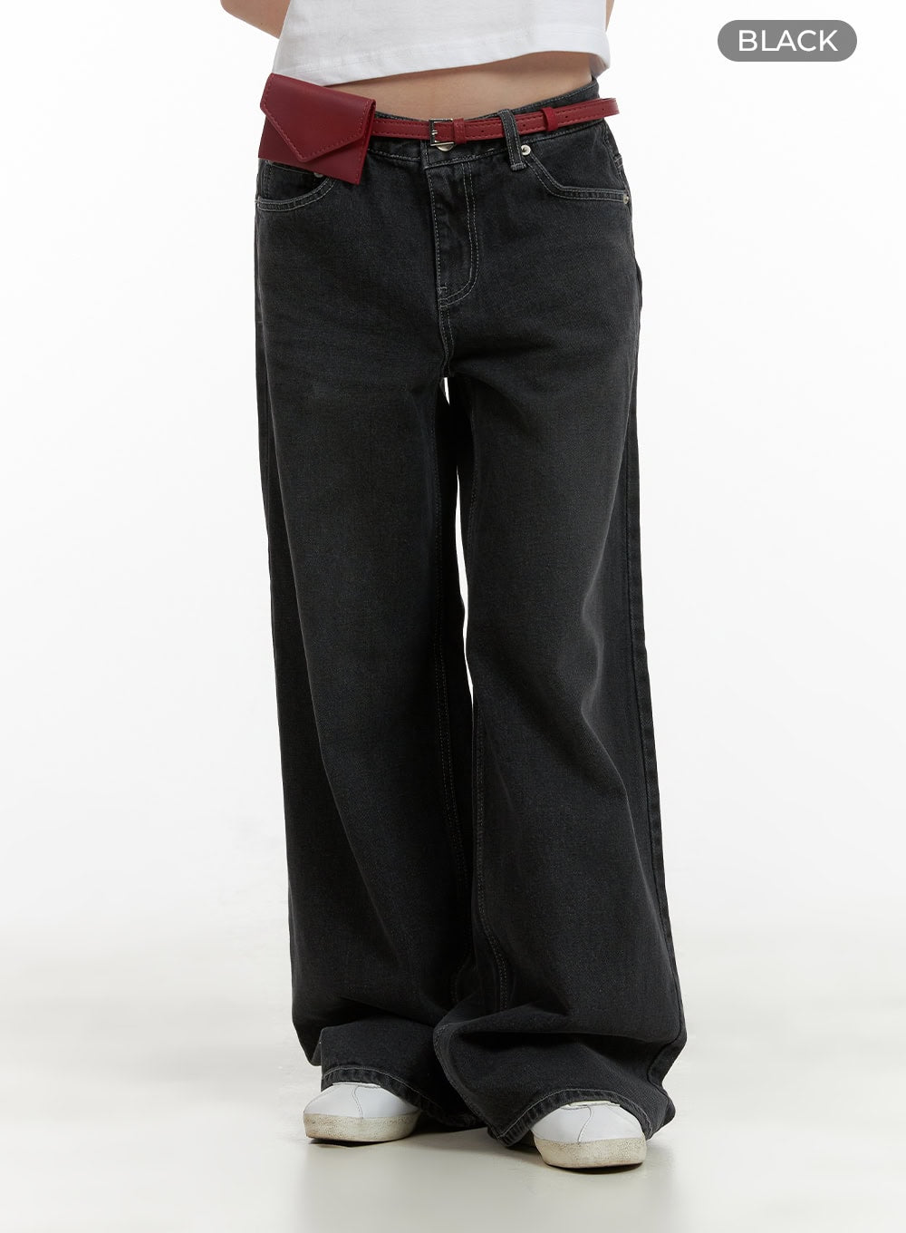 Low Rise Baggy Jeans CU410 in black, front product-focus shot on model, low-rise waistband and extra-wide washed denim leg, paired with red mini belt bag.