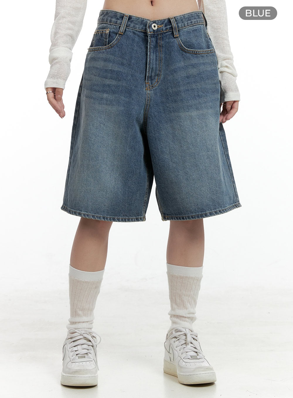 Low Rise Bermuda Jorts CL424 in blue, front waist-to-hem shot on model, wide-leg washed denim jorts, low rise with button fly and front pockets, paired with white socks and sneakers.