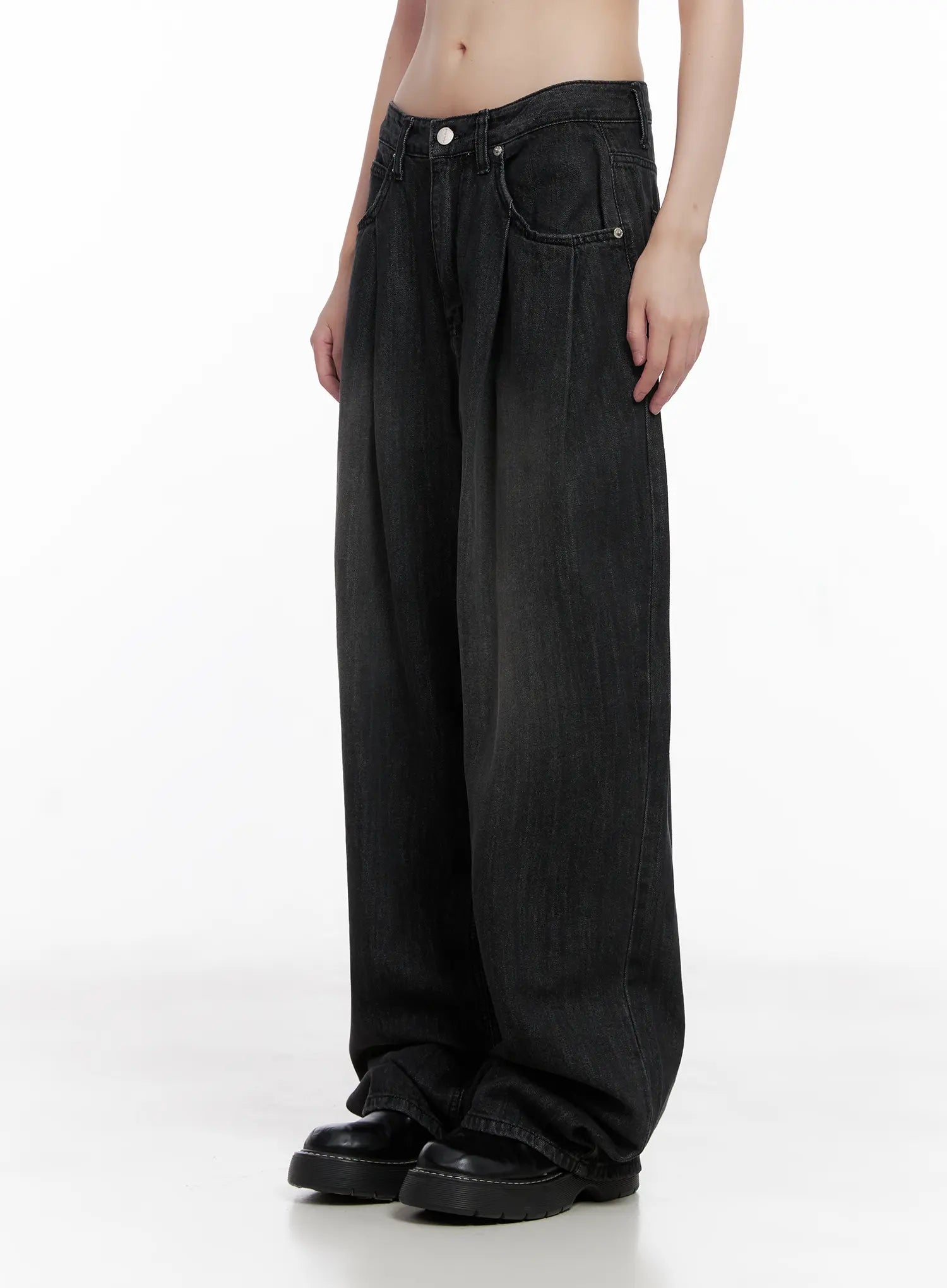 Elen Pintuck Baggy Jeans CG519 in black, angled front-side view on model, pintuck pleats and front pockets clearly visible, washed oversize cotton denim, with black chunky boots.