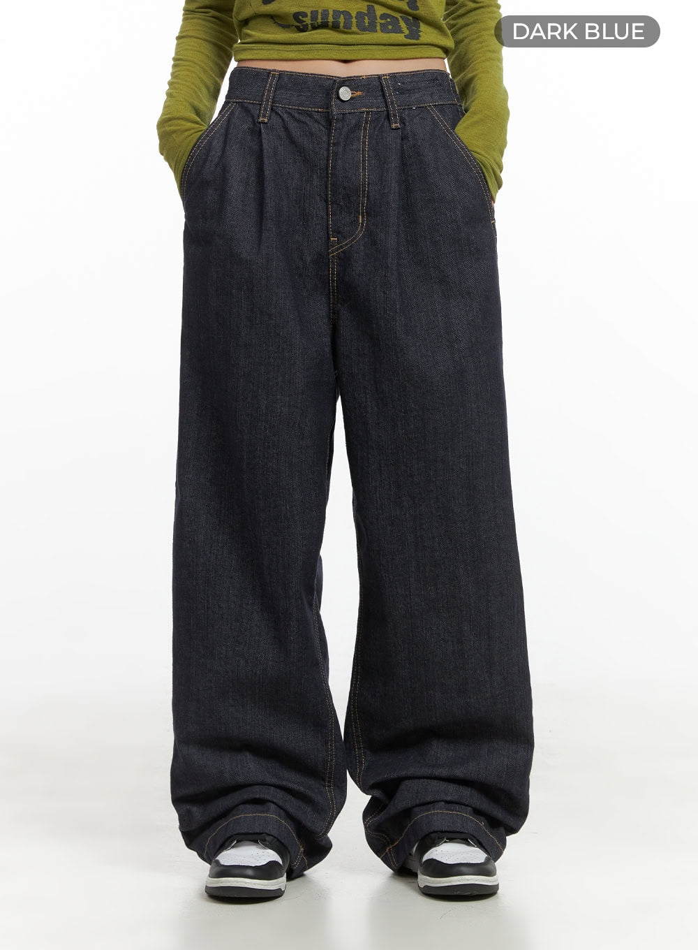 Lola Pintuck Baggy Jeans CO402 in dark blue, front waist-to-hem product shot on model, pintuck pleats and button fly clearly visible, wide-fit denim stacking over sneakers.