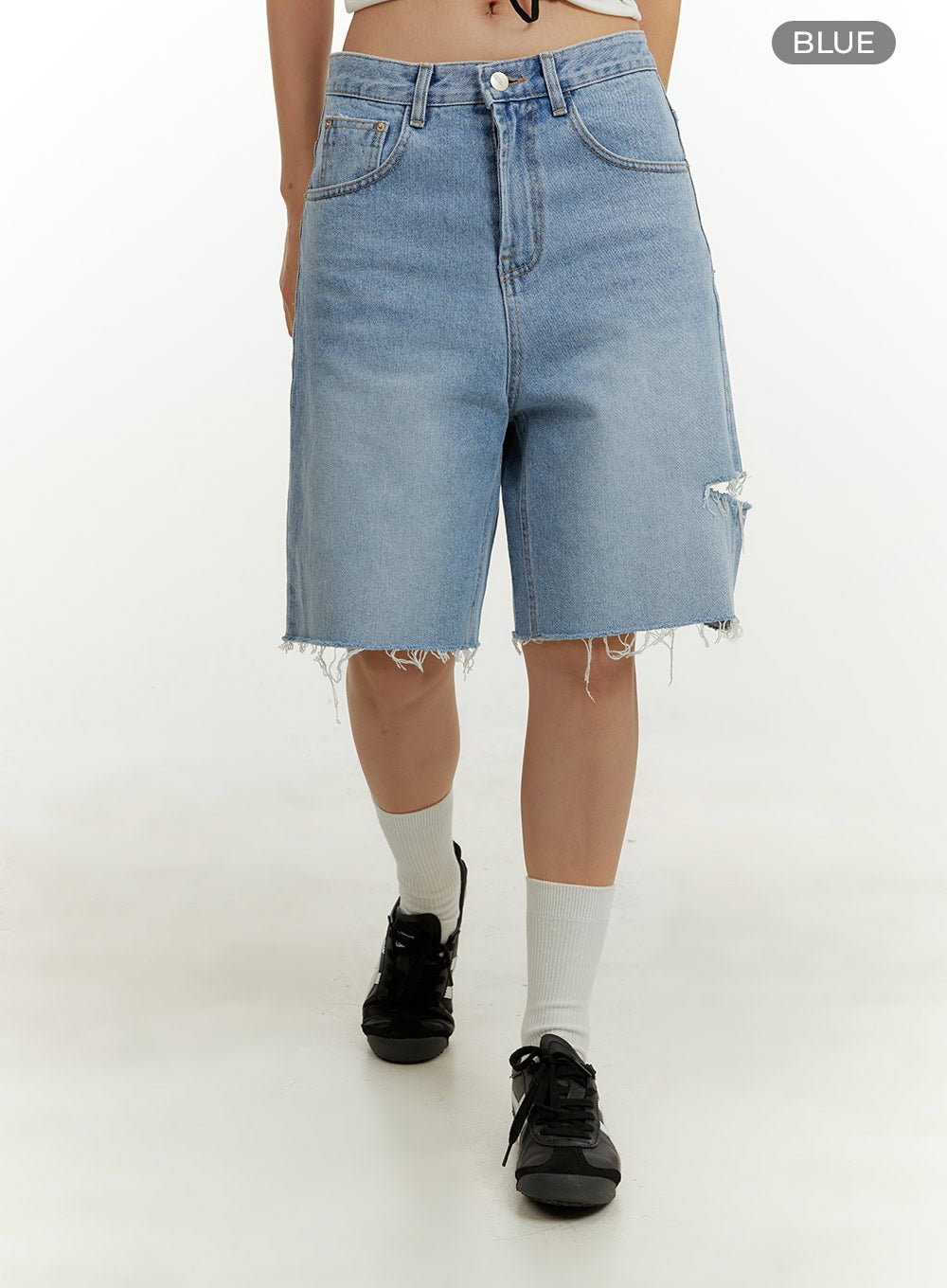 Straight Leg Jorts CY408 in blue, front walking shot on model, wide-fit washed cotton denim, destroyed rip on right thigh, frayed raw-cut hem, 5-pocket construction, color swatch labeled BLUE.