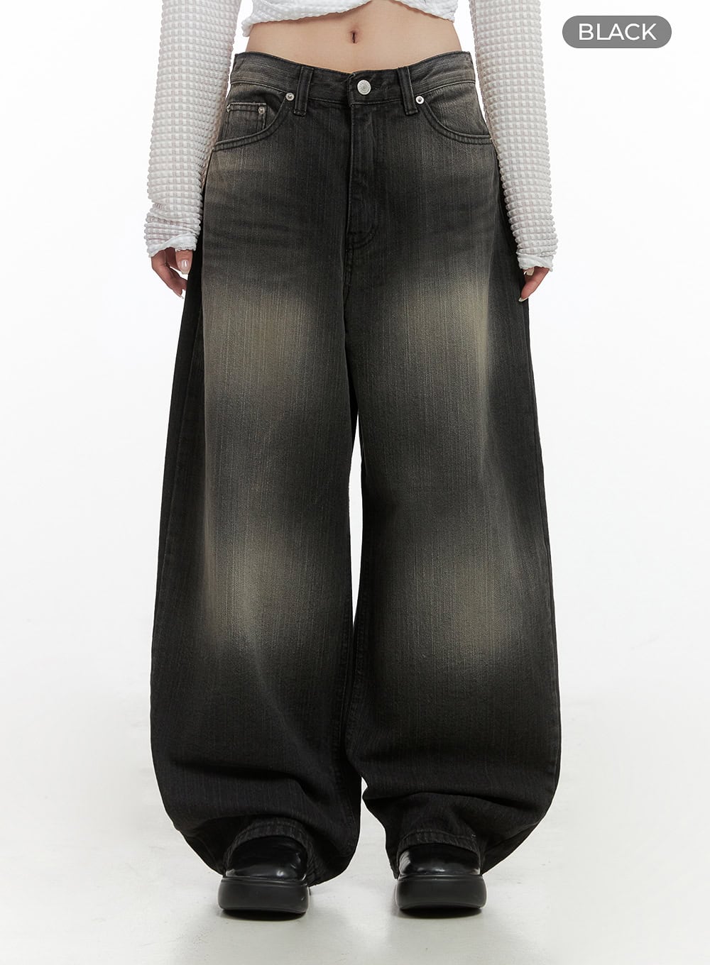 Sage Back-Buttoned Wide Pants CS430 in black, front full-length on model, color-label BLACK, ultra-wide baggy washed denim with golden fade whiskers, low rise, hem stacking over black platform shoes.