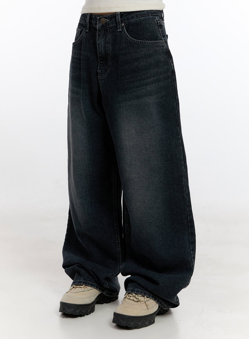 Camila Washed Cotton Jeans CN422 in dark blue, side full-length shot on model, oversize baggy wide-leg washed cotton denim, pooling hem at ankle, paired with chunky sneakers.