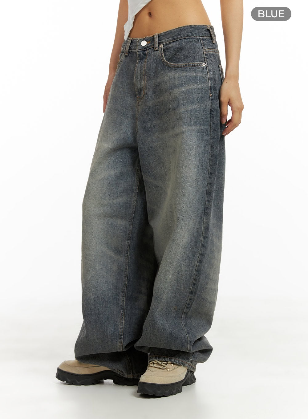 Vintage Washed Baggy Jeans CA424 in blue, front-side color reference shot on model, wide-leg cotton denim with heavy vintage wash gradient, low rise, relaxed silhouette, hem stacking over sneakers.