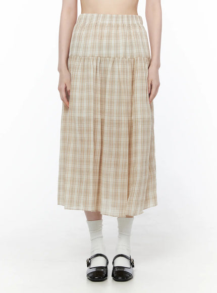 Plaid Flare Maxi Skirt CU519 in beige, front full skirt shot on model from waist to hem, showing tiered flare silhouette, elastic waist, semi-sheer plaid weave, paired with white socks and black Mary Janes.