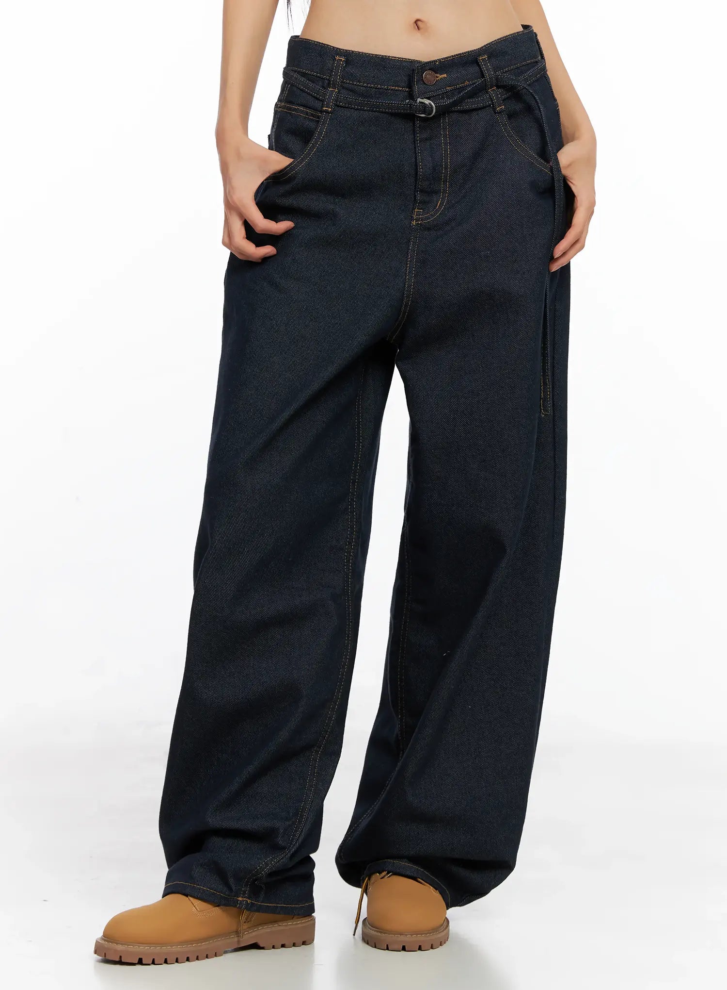 Alanna Sun Belt Baggy Jeans CO528 in dark indigo, front waist-to-hem view on model, low-rise loose fit with sun belt ring closure, side pockets, and contrast orange topstitching.
