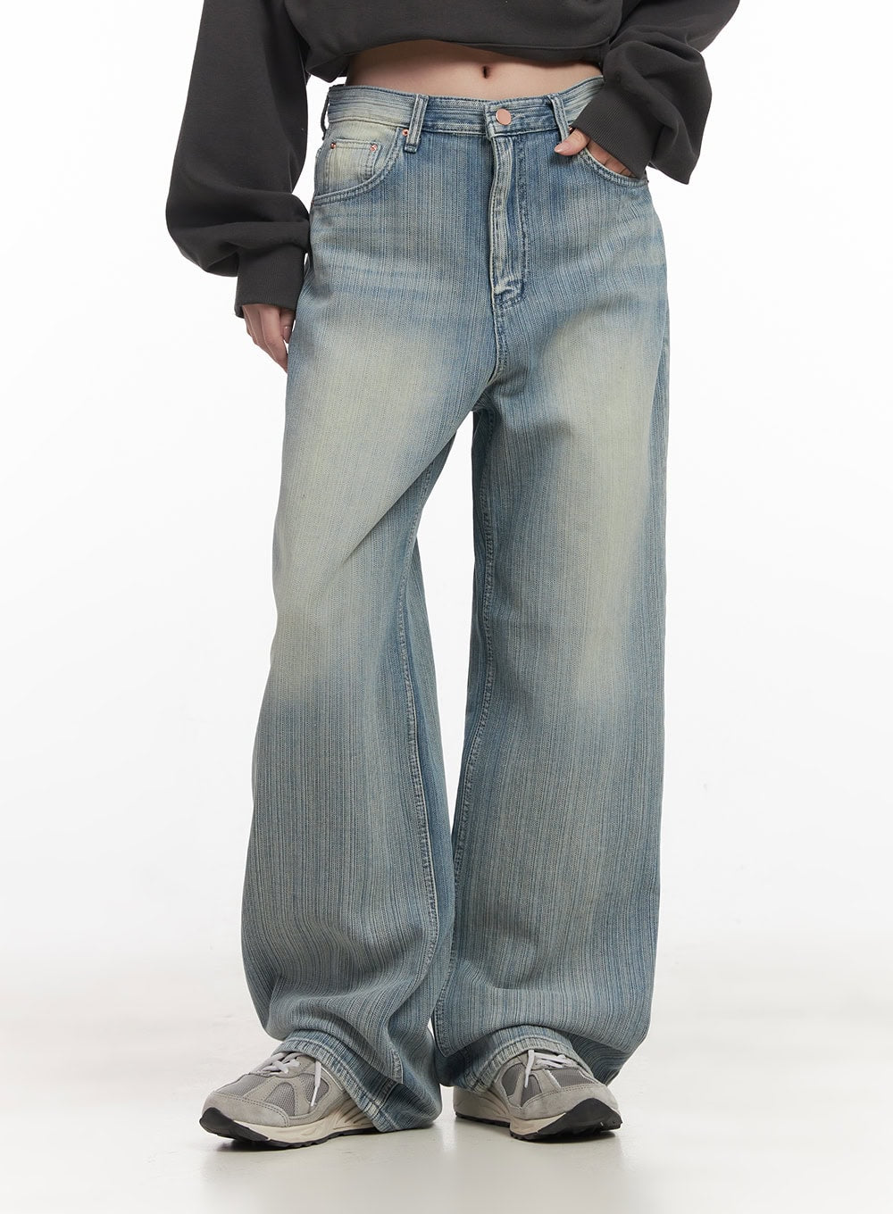 Nicola Washed Wide-Leg Jeans CF514 in light blue, front mid-body close-up on model, highlighting waistband button closure, five-pocket construction, and vertical washed texture.