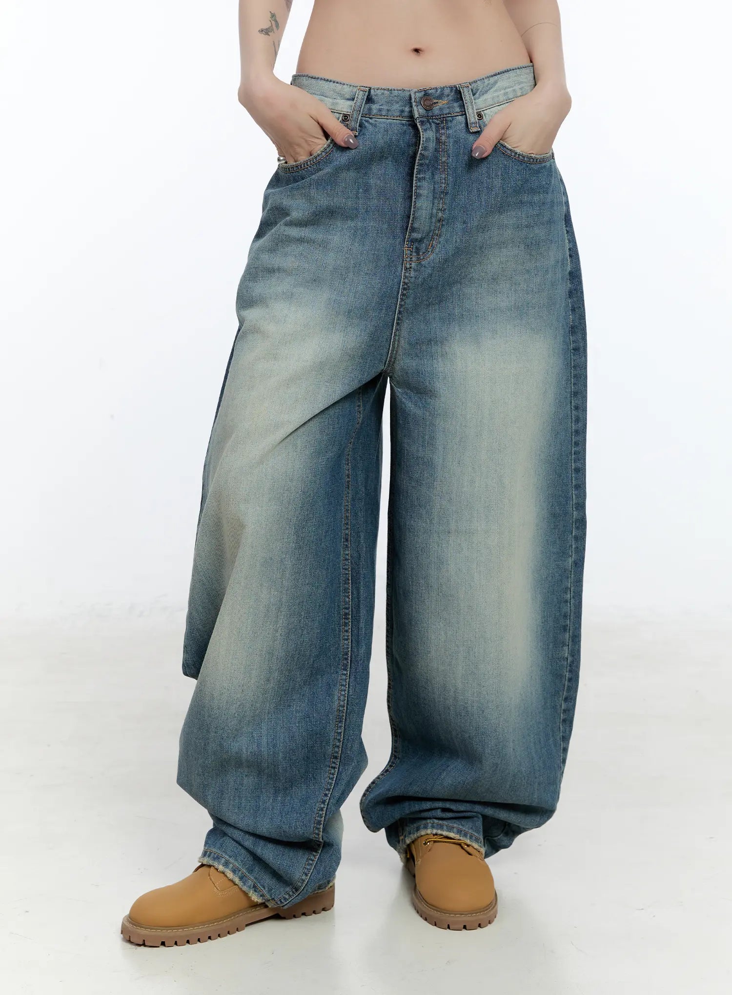 Jiso Baggy Wide Jeans CN517 in blue, three-quarter front shot on model with hands in pockets, washed baggy wide leg with dramatic volume through thigh, mid-rise waistband detail.