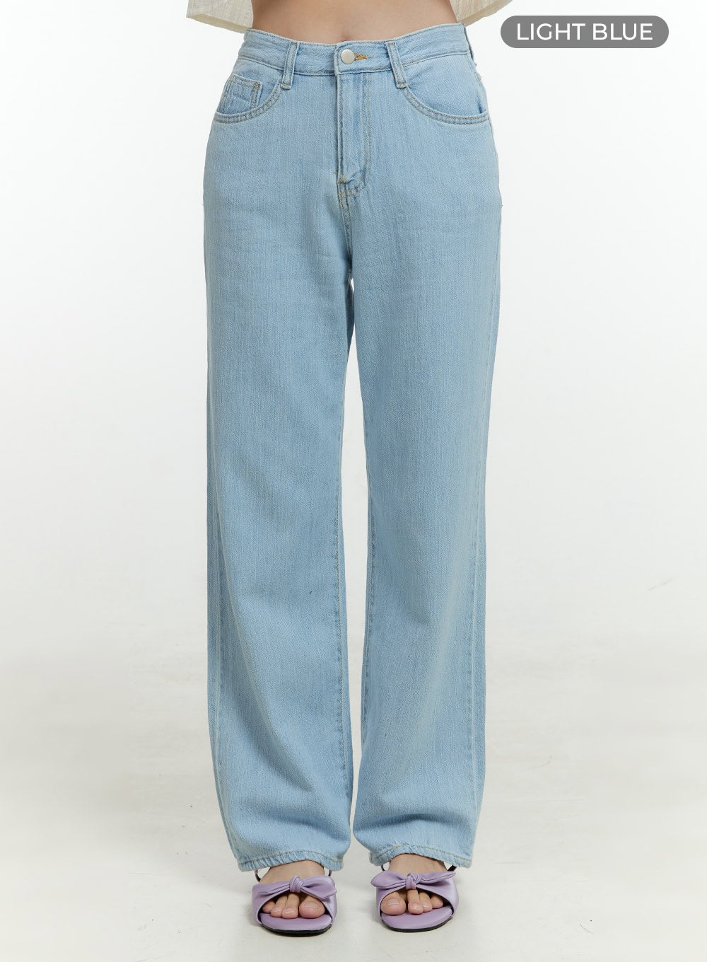 Ava Light Washed Straight Jeans OL430 in light blue, front waist-to-hem product shot on model, high-rise five-pocket wide straight leg, light washed denim with contrast stitching and gold button closure.