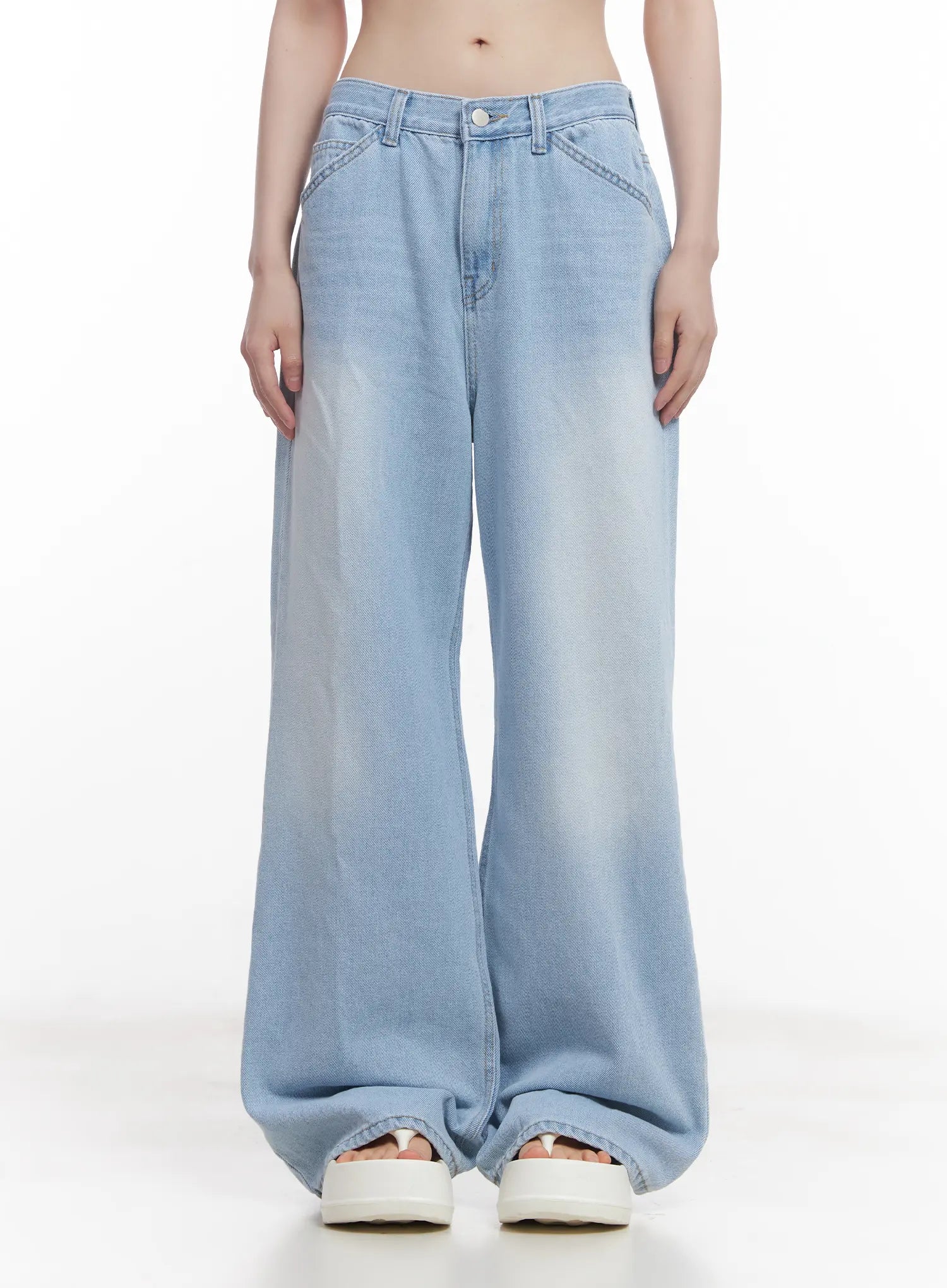 Haerin Washed Wide-Leg Jeans CU519 in light blue, front waist-to-hem shot on model, low-rise waistband with button closure and angled pocket seams, washed wide-leg cotton denim.