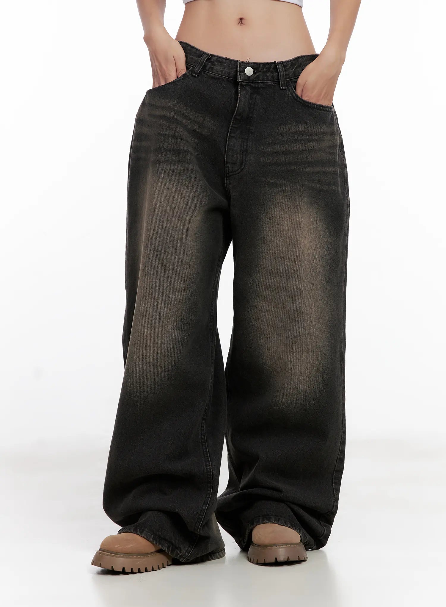 Ari Washed Wide-Leg Denim Jeans CL521 in Black, front mid-body shot on model, low-rise waistband, wide cotton leg with washed fade, hands in pockets, paired with chunky sandals.