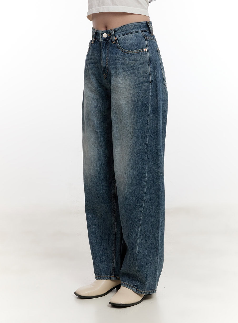 Belle Washed Wide-Leg Jeans CF528 in blue, angled side view on model, showcasing wide-leg drape, washed fading gradient, and 5-pocket construction with cream mule heels.