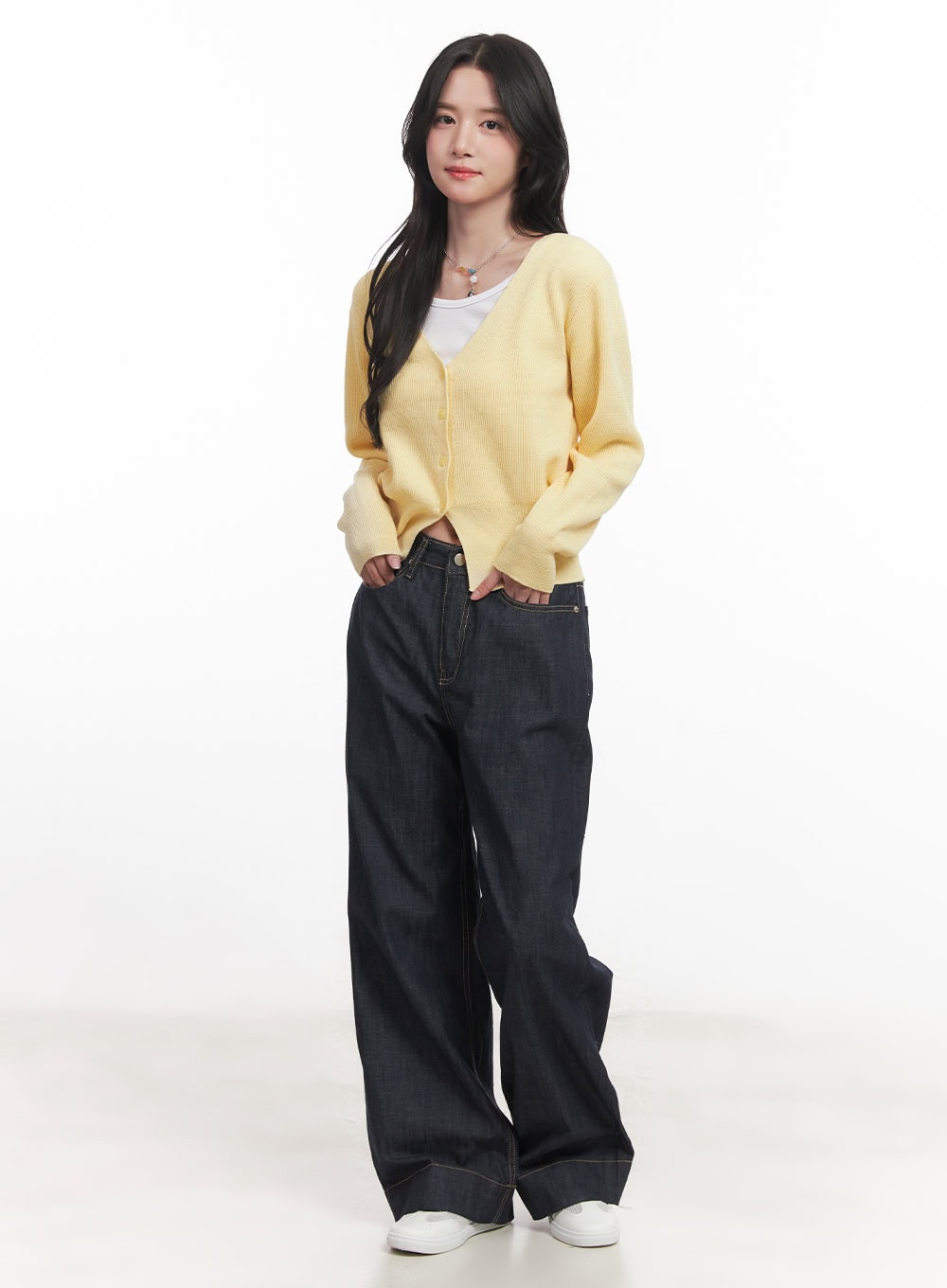 Seline Non-Fade Wide-Leg Jeans CA510 in dark blue, full-body front view on model, wide-leg denim paired with yellow knit cardigan over white tee and white sneakers, casual layered look.