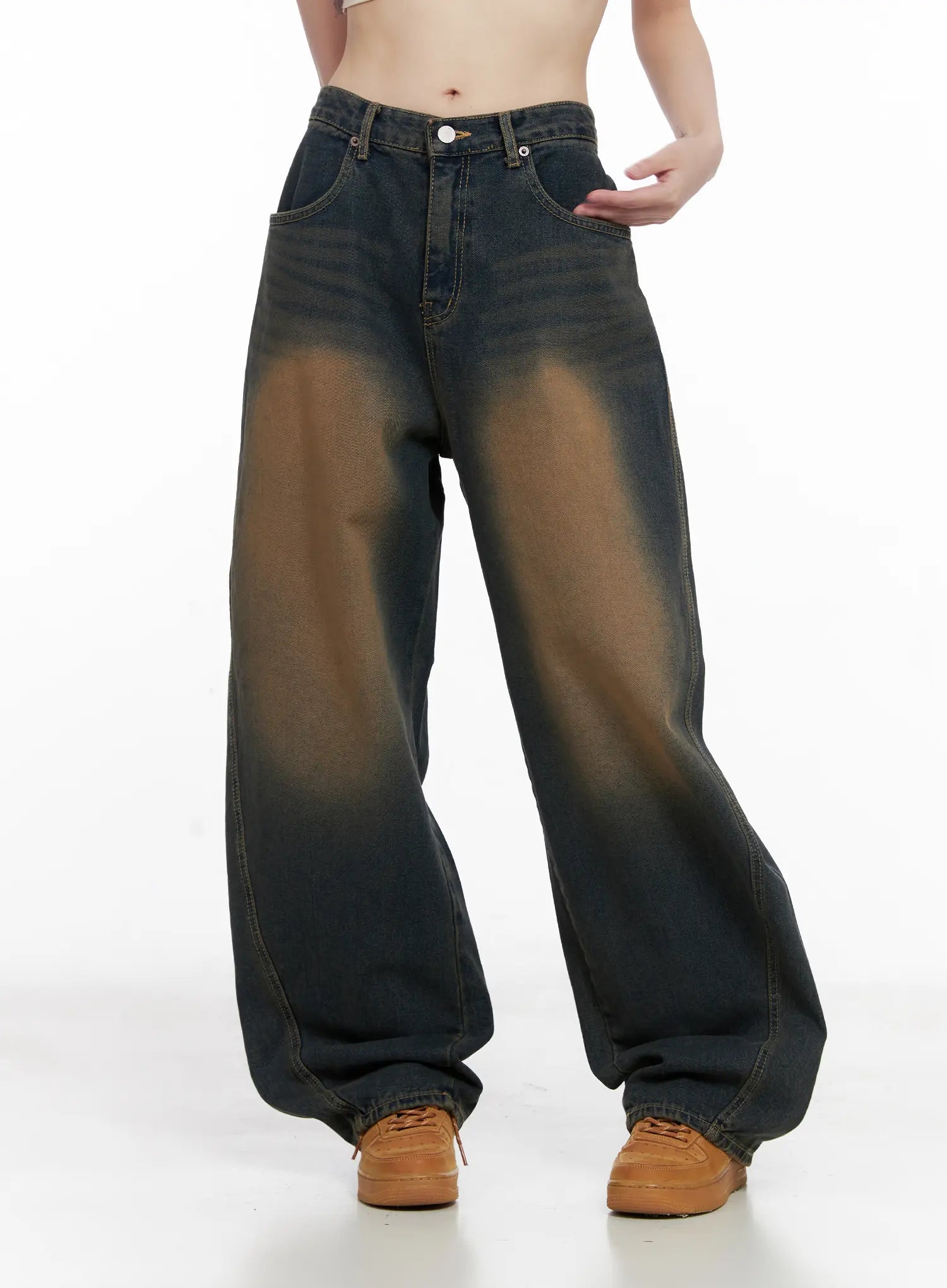 Jaycee Vintage Wash Baggy Jeans CG519 in dark blue, front three-quarter view on model, emphasizing relaxed wide fit, prominent brown sun-fade wash, and long cotton denim length.