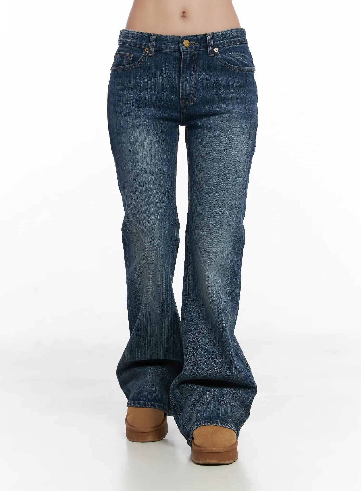 Astrid Low Rise Flared Bootcut Jeans CJ514 in blue, front full-length product shot on model, wide flared leg with washed vintage-look denim, low-rise gold button closure, long length.