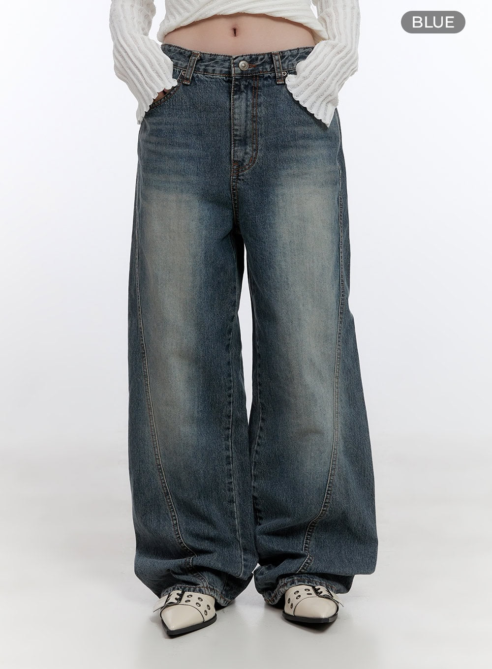 Lucia Stitched Denim Baggy Jeans CO418 in blue, front crop product view on model, wide-fit washed denim with curved center stitch seam clearly visible, color label shown.