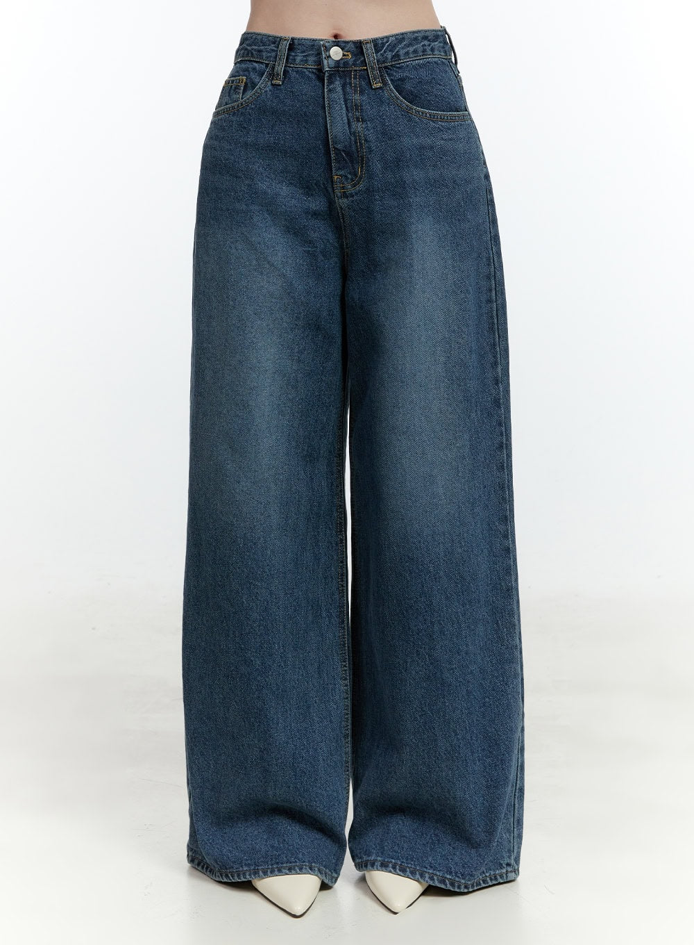 Klaudia Wide-Leg Jeans CF503 in blue, front product-style shot on model, high-waist washed denim, wide-leg silhouette with button fly and 5-pocket construction, white pointed-toe heels.